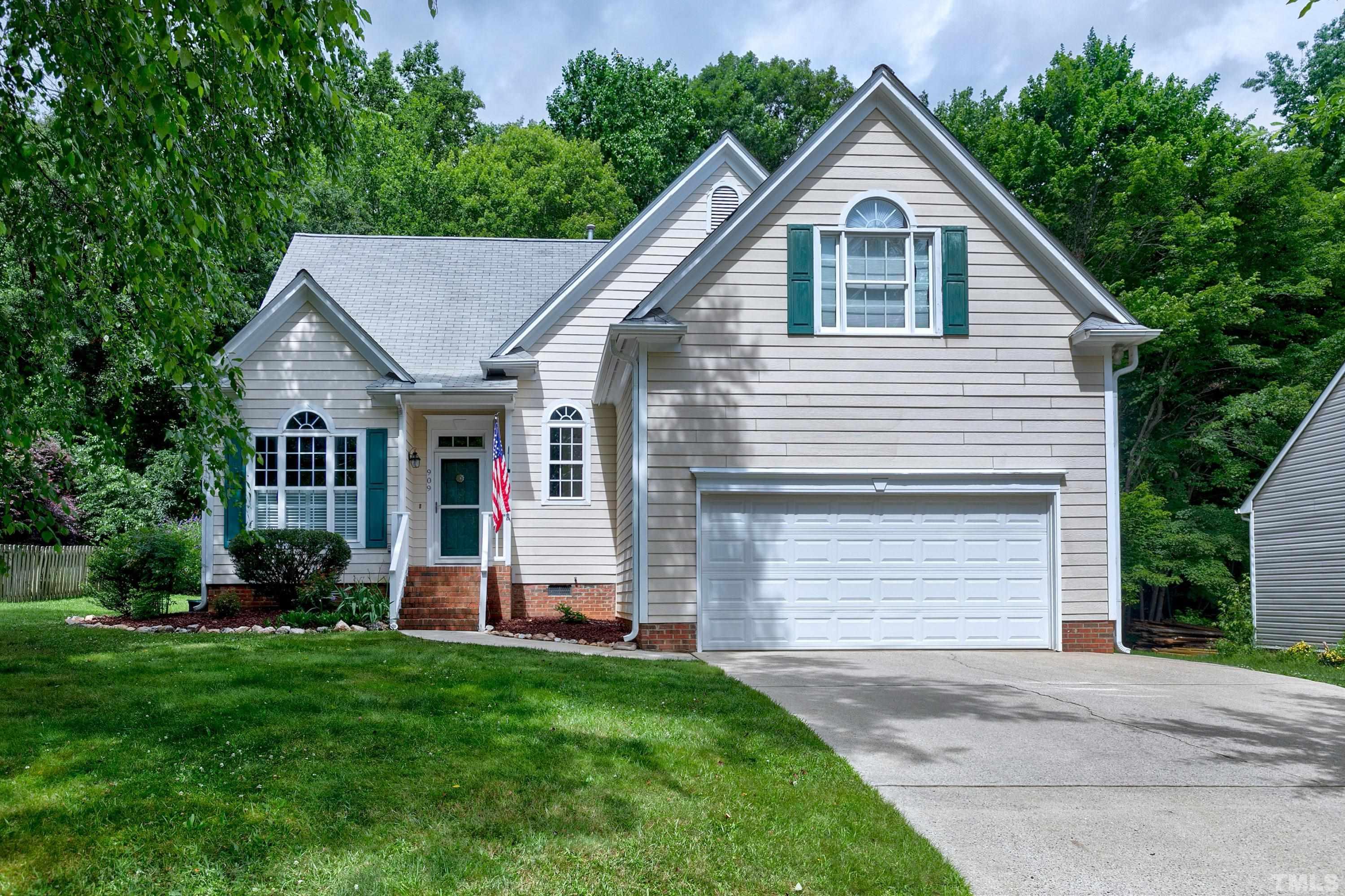909 Cedar Downs Drive Raleigh, NC 27607 - Photo 1 of 32 a front view of a house with a yard and garage