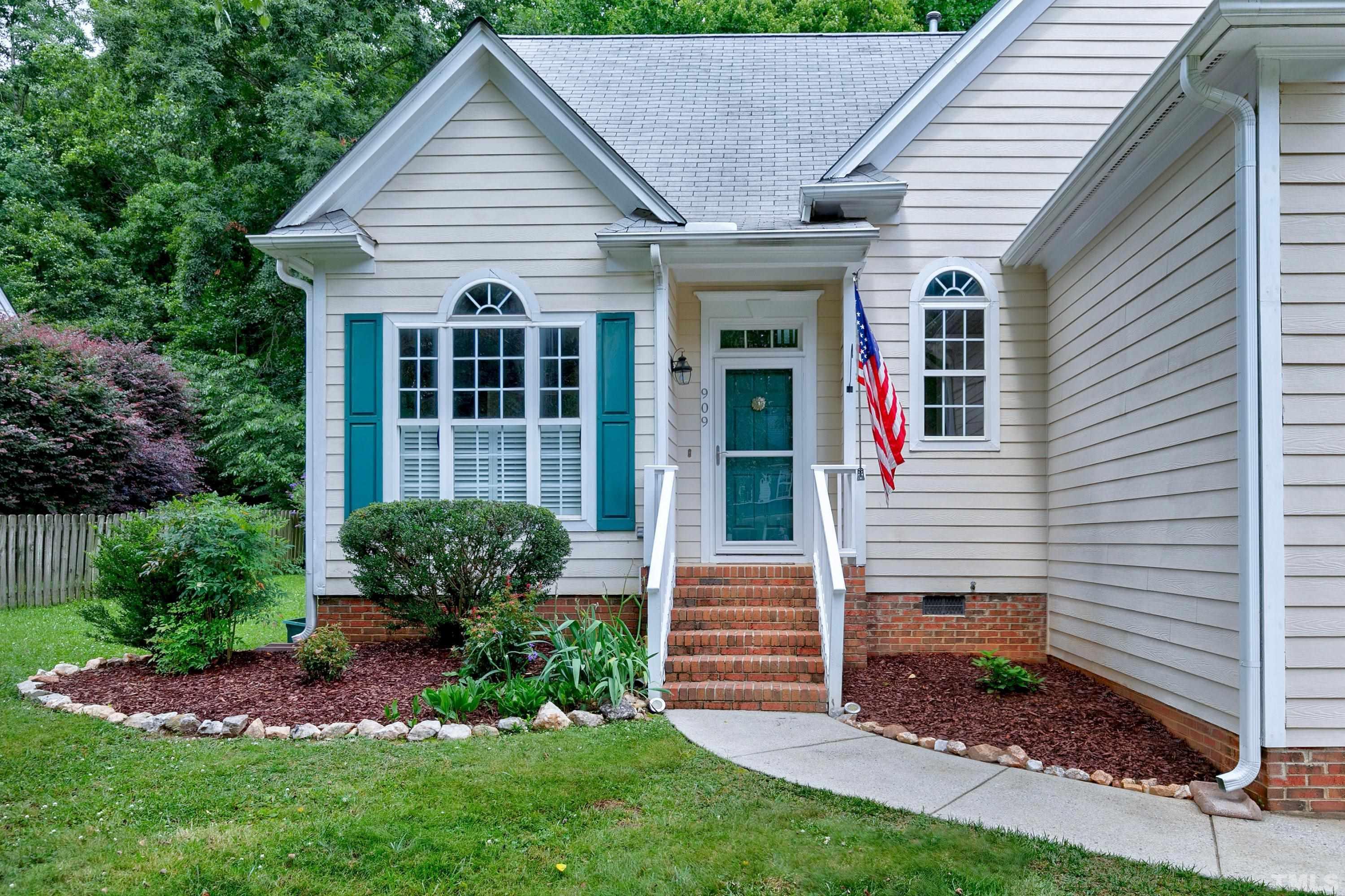 909 Cedar Downs Drive Raleigh, NC 27607 - Photo 2 of 32 a view of a house with garden