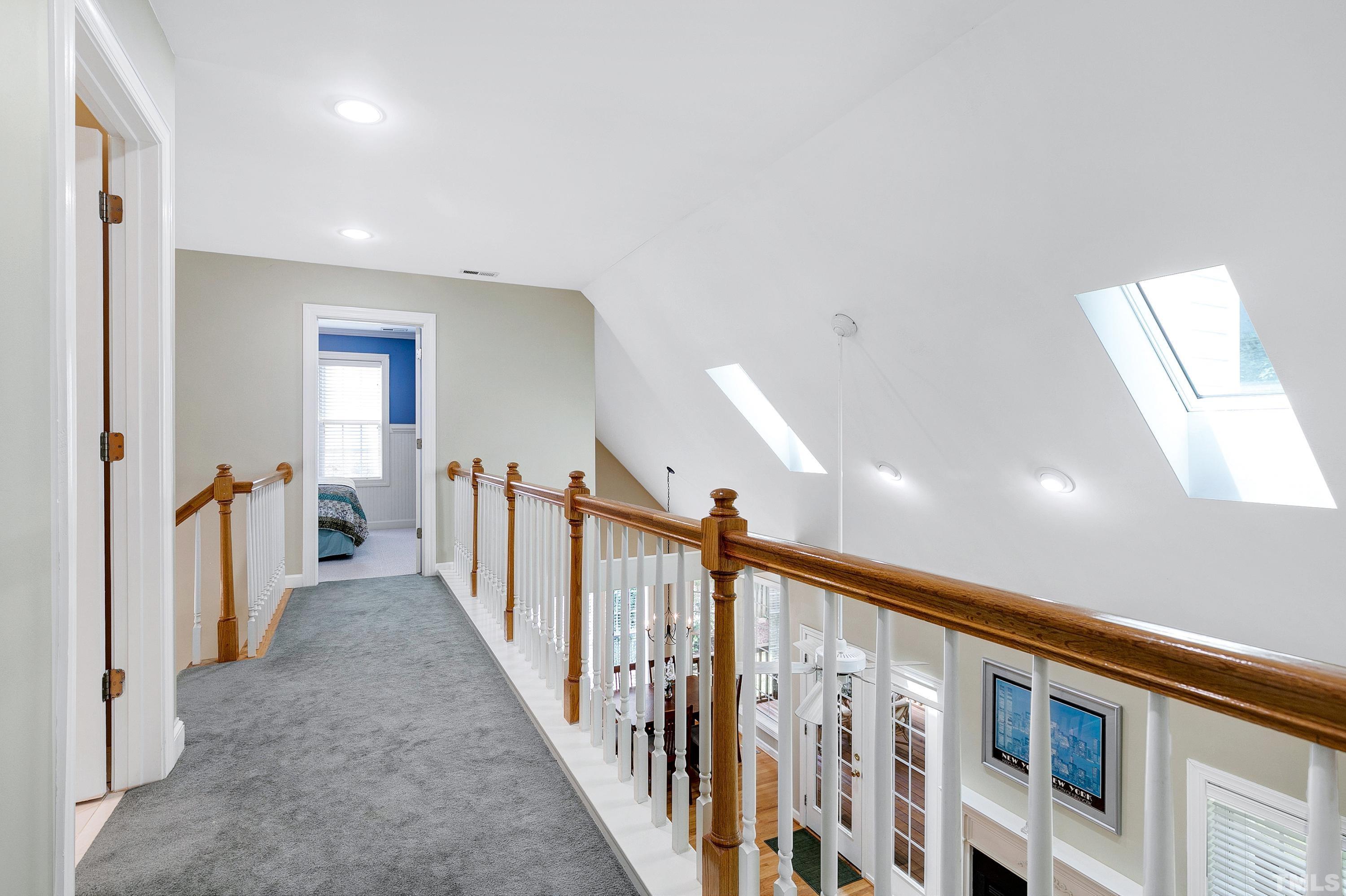 909 Cedar Downs Drive Raleigh, NC 27607 - Photo 22 of 32 a view of a hallway with a livingroom and stairs