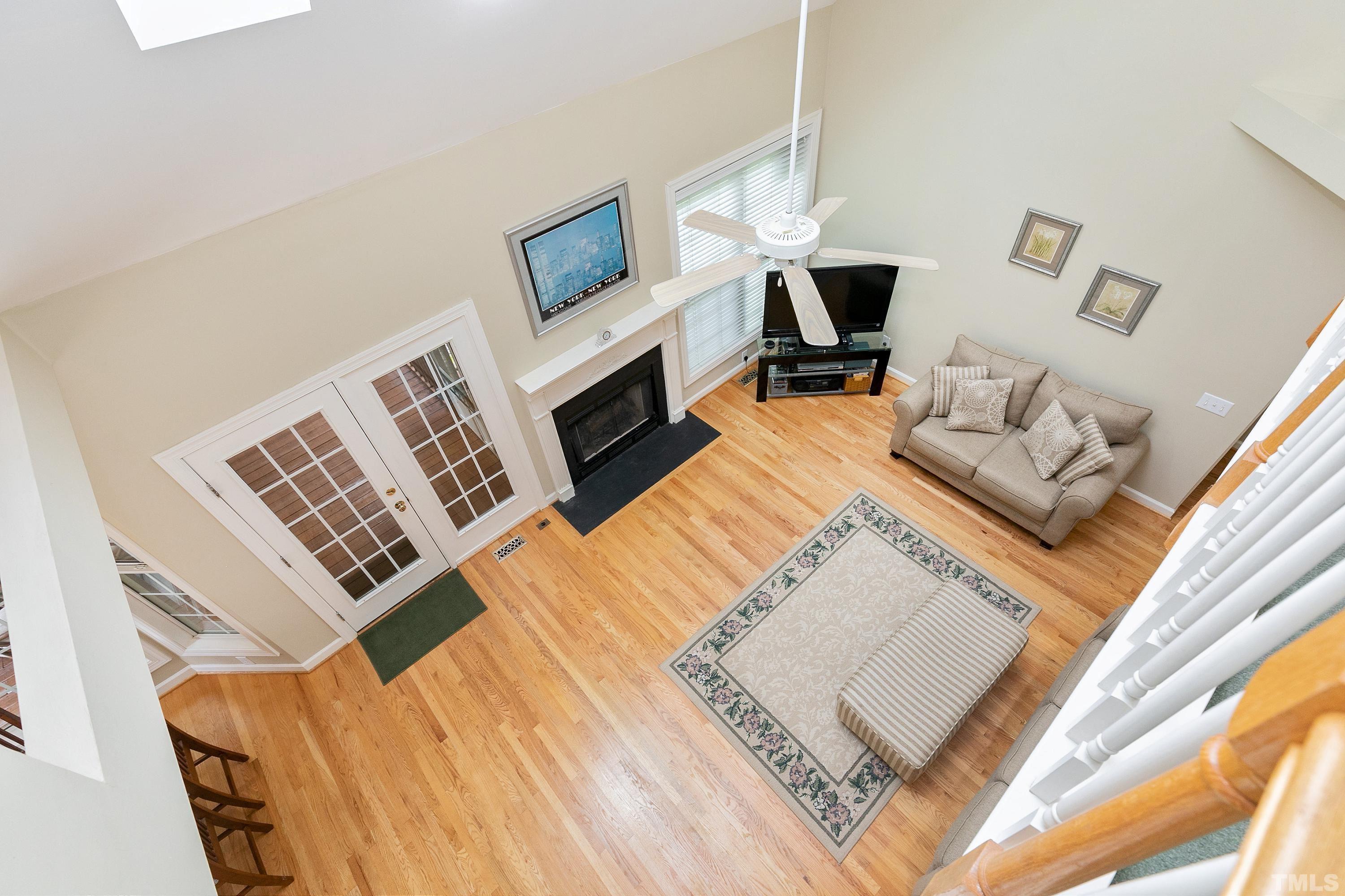 909 Cedar Downs Drive Raleigh, NC 27607 - Photo 26 of 32 a living room with furniture fireplace and flat screen tv
