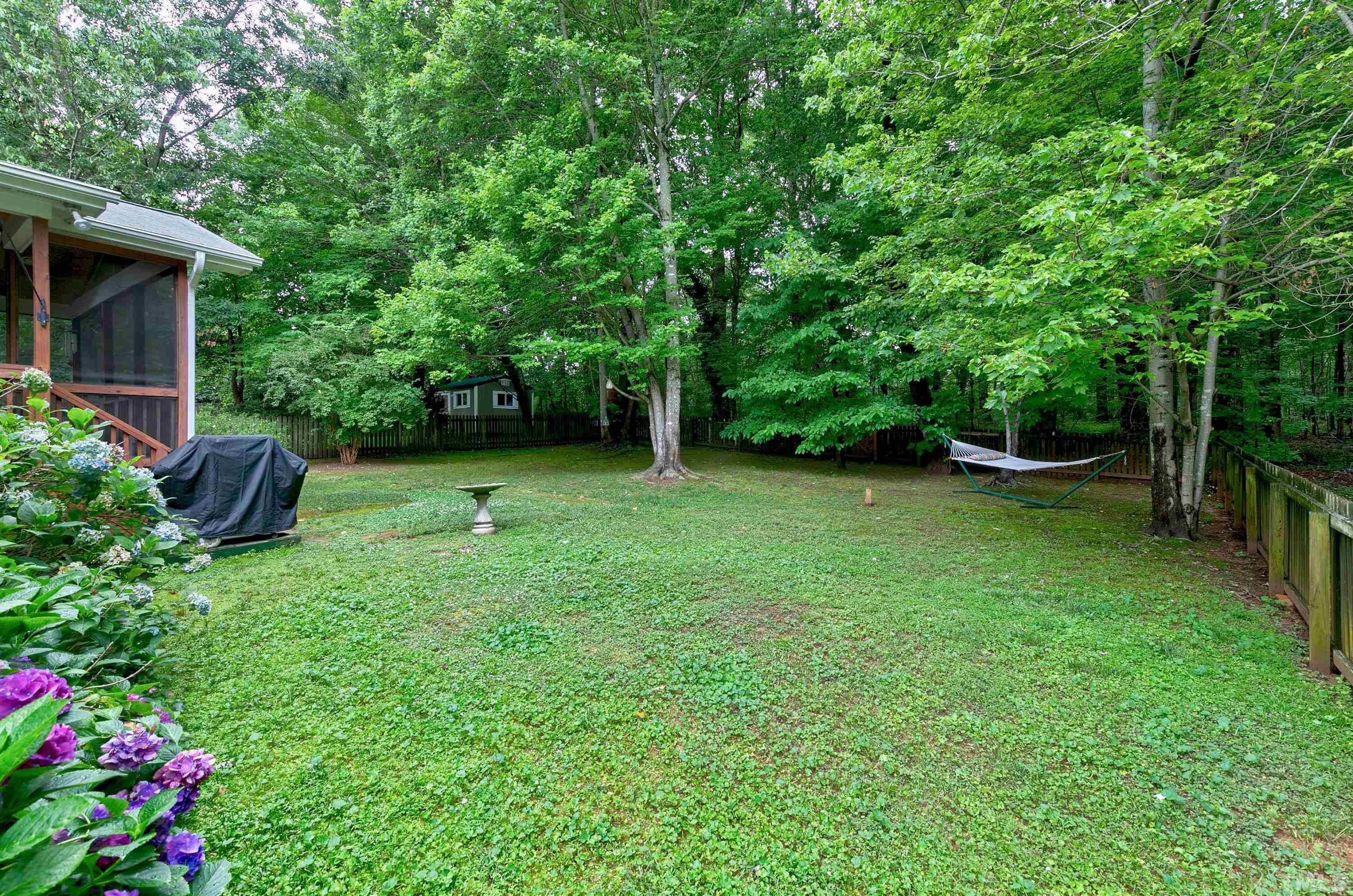 909 Cedar Downs Drive Raleigh, NC 27607 - Photo 3 of 32 a view of a backyard with a garden