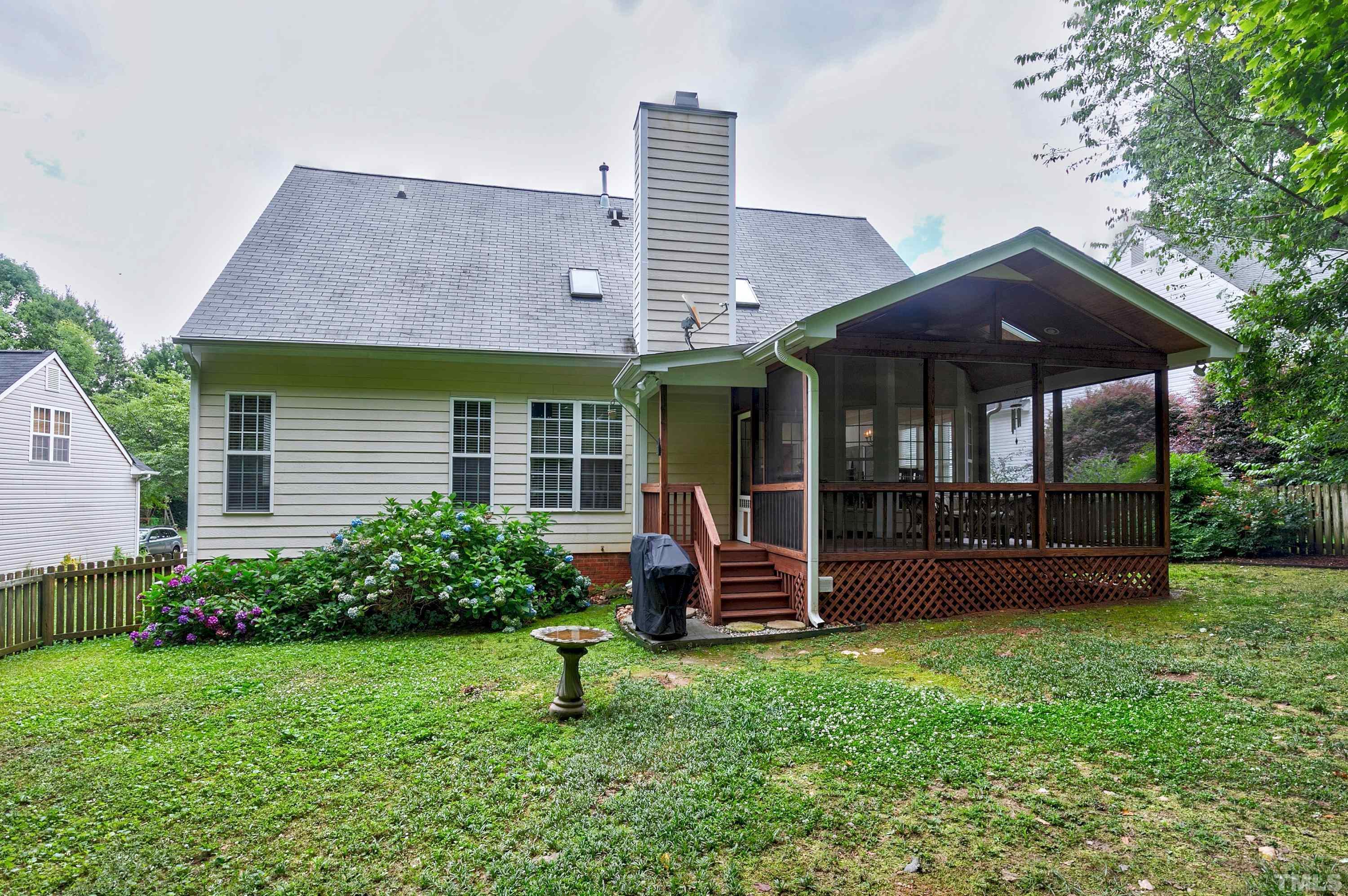 909 Cedar Downs Drive Raleigh, NC 27607 - Photo 31 of 32 a view of a house with a backyard