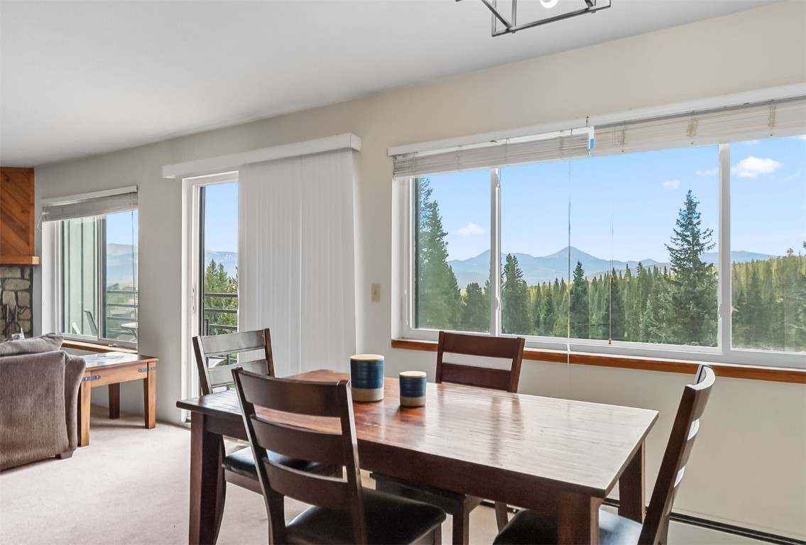 9849 Ryan Gulch Road, Unit 203 Silverthorne, CO 80498 - Photo 11 of 35 a view of a dining room with furniture window and outside view