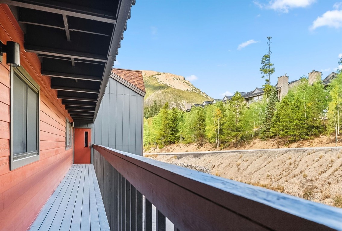 9849 Ryan Gulch Road, Unit 203 Silverthorne, CO 80498 - Photo 28 of 35 a view of balcony with wooden floor and fence