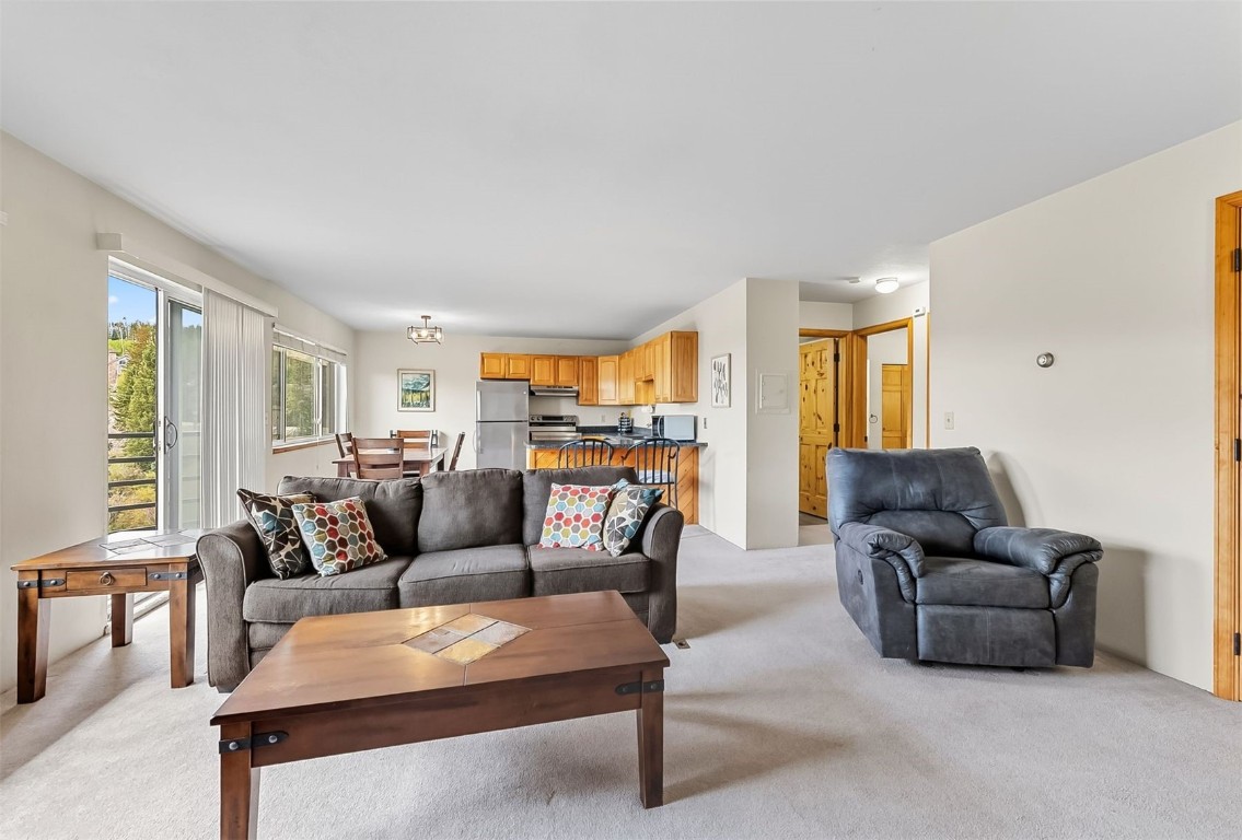 9849 Ryan Gulch Road, Unit 203 Silverthorne, CO 80498 - Photo 10 of 35 a living room with furniture and a large window