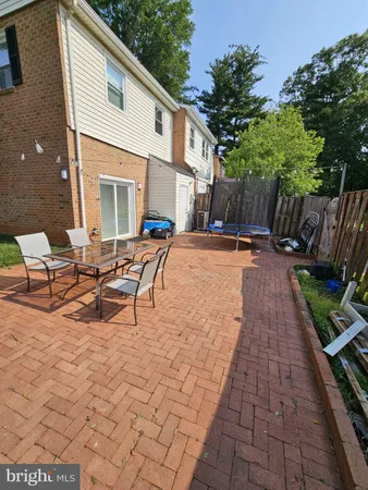 a wooden bench sitting in front of a house