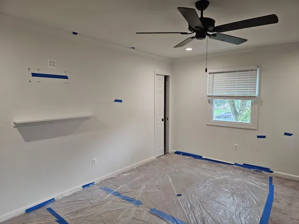 a view of a big room with wooden floor closet and windows