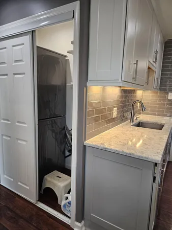 a room with a sink and cabinets
