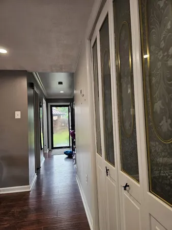 a view of a hallway with wooden floor