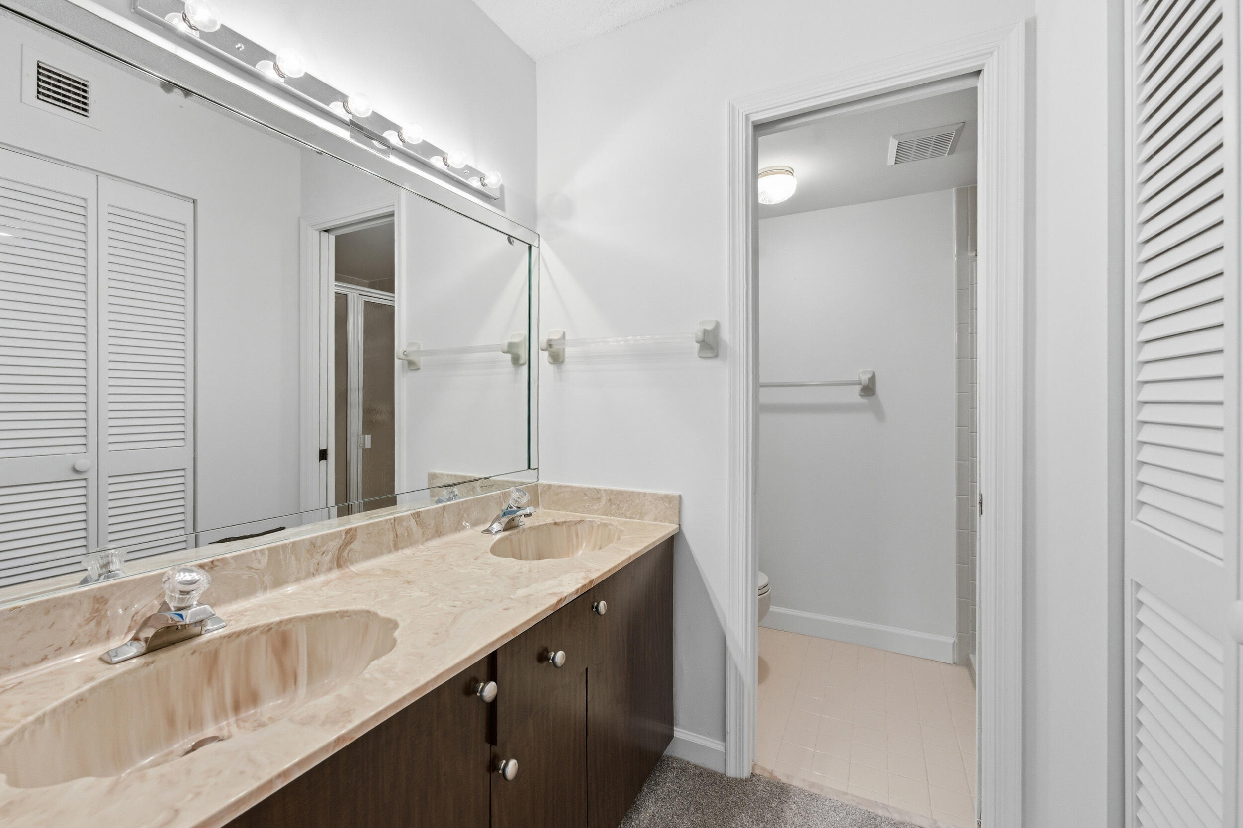 9633 Riverside Drive, Unit E3 Coral Springs, FL 33071 - Photo 14 of 31 a bathroom with a granite countertop sink a mirror and a bathtub