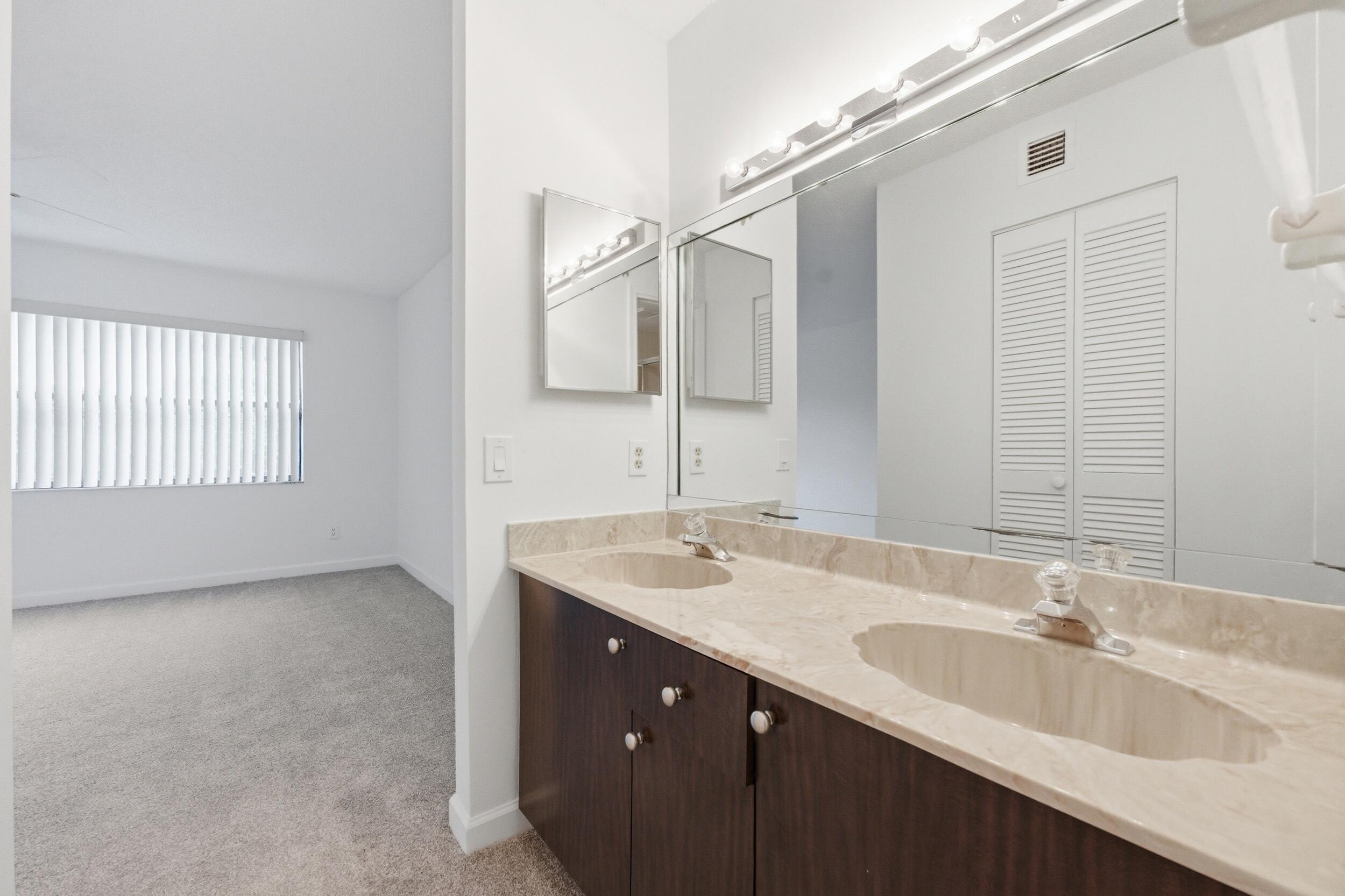 9633 Riverside Drive, Unit E3 Coral Springs, FL 33071 - Photo 15 of 31 a bathroom with a sink double vanity granite and a mirror
