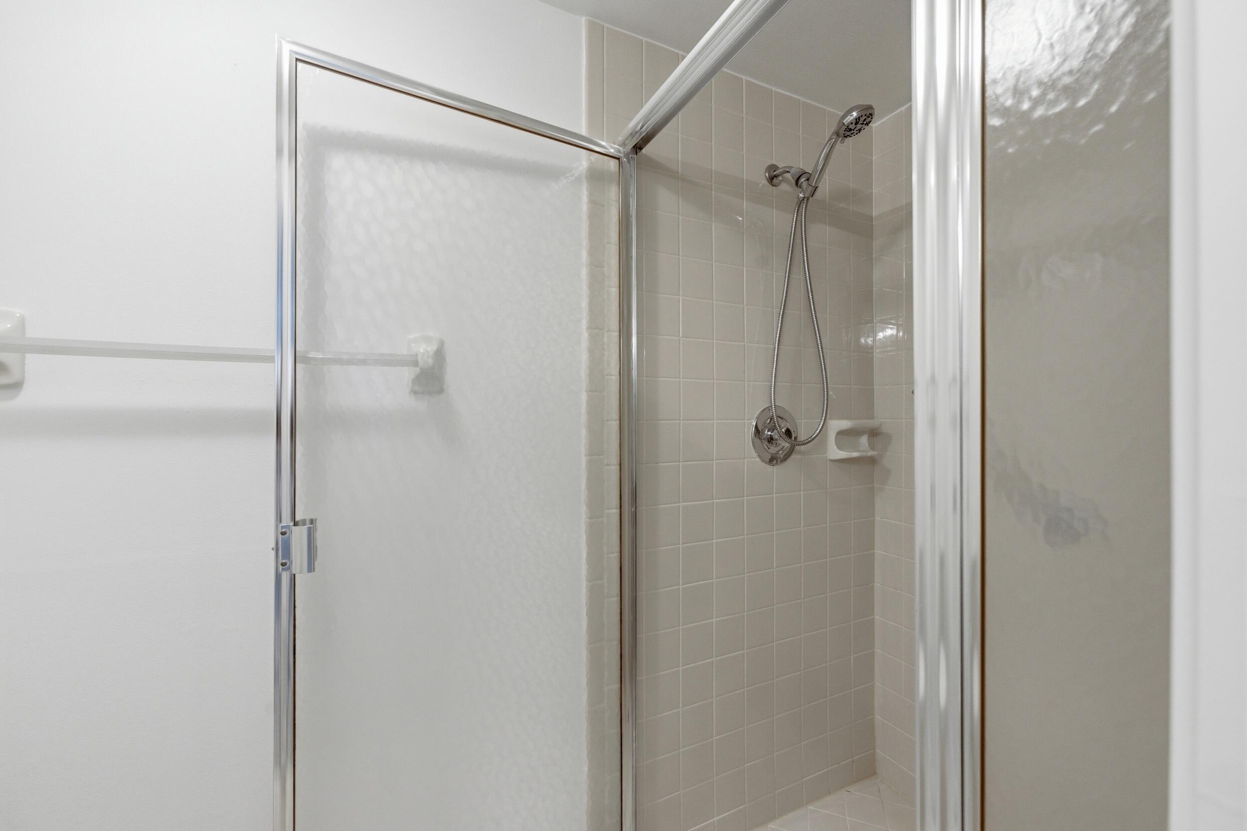9633 Riverside Drive, Unit E3 Coral Springs, FL 33071 - Photo 16 of 31 a bathroom with a glass shower door