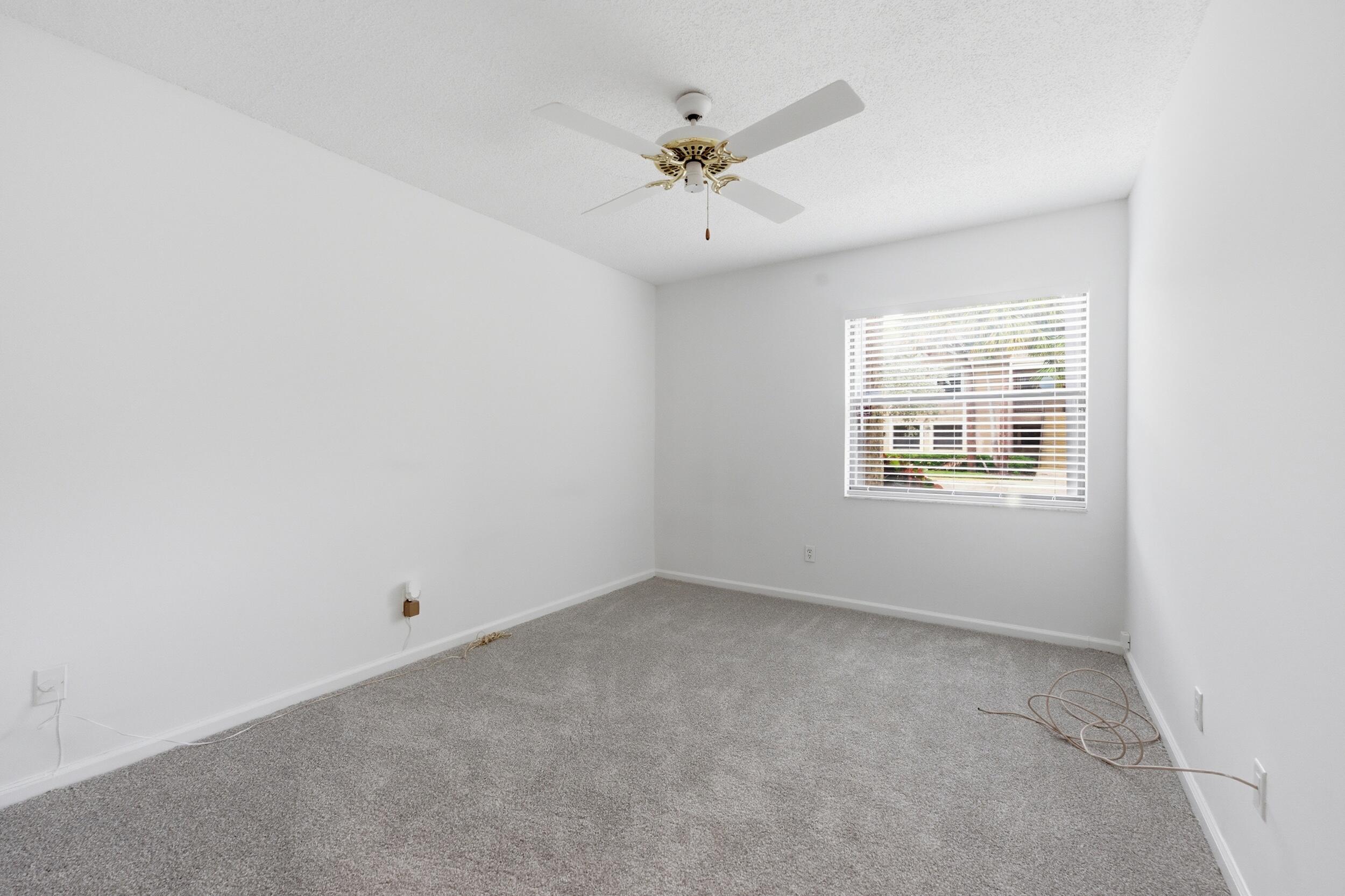 9633 Riverside Drive, Unit E3 Coral Springs, FL 33071 - Photo 18 of 31 an empty room with a window and a ceiling fan