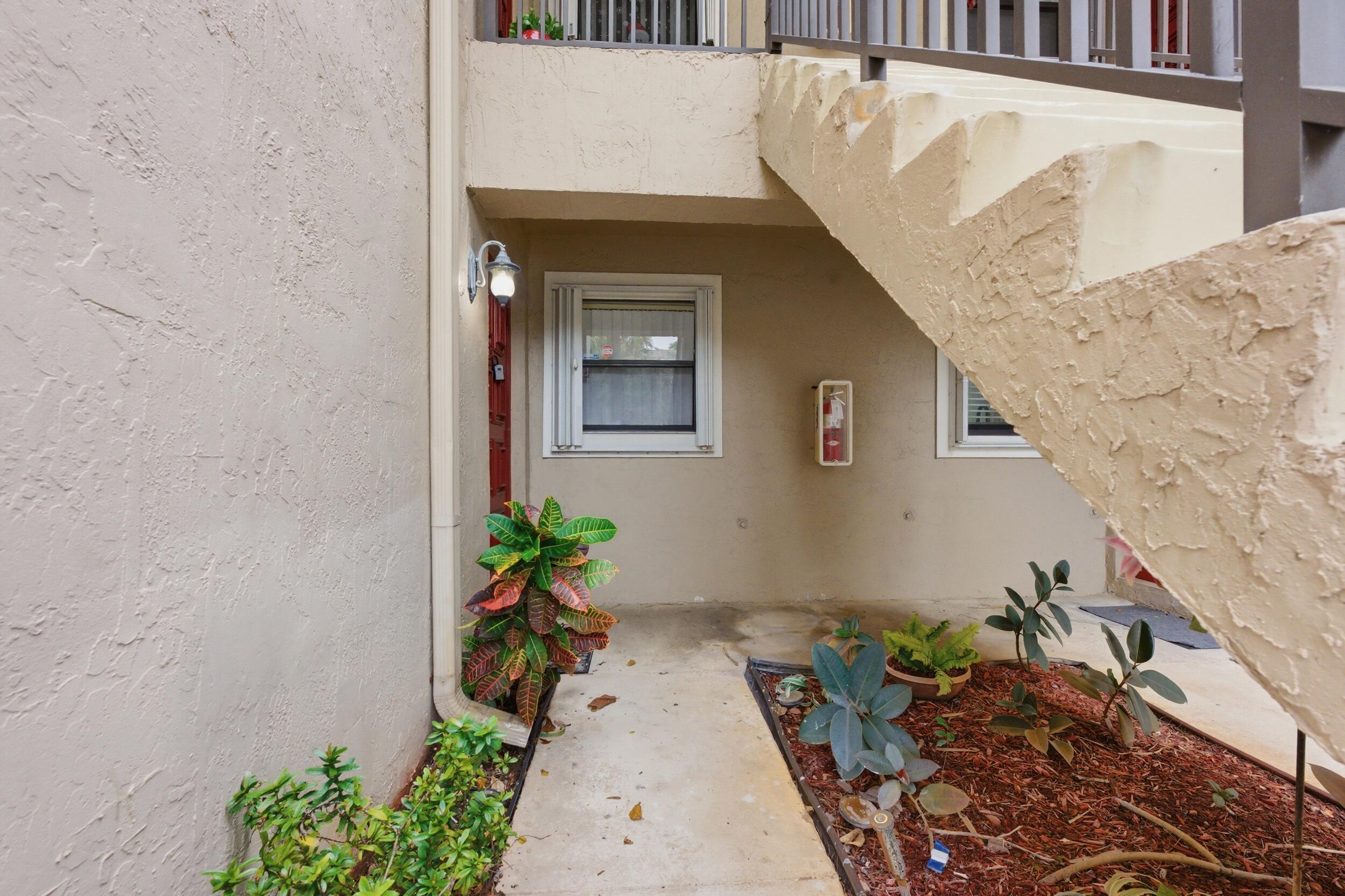 9633 Riverside Drive, Unit E3 Coral Springs, FL 33071 - Photo 2 of 31 a front view of a house with a yard