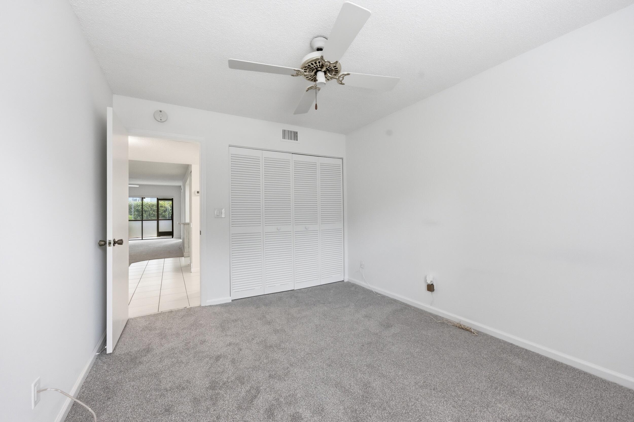9633 Riverside Drive, Unit E3 Coral Springs, FL 33071 - Photo 21 of 31 an empty room with a ceiling fan and a window