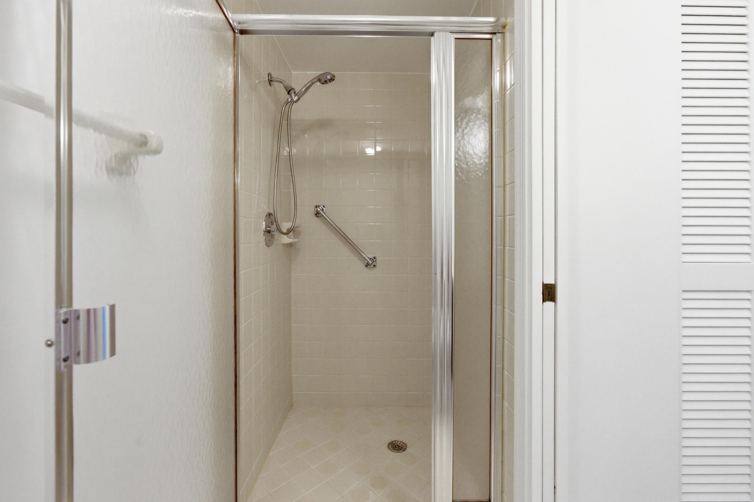 9633 Riverside Drive, Unit E3 Coral Springs, FL 33071 - Photo 25 of 31 a bathroom with a glass shower door
