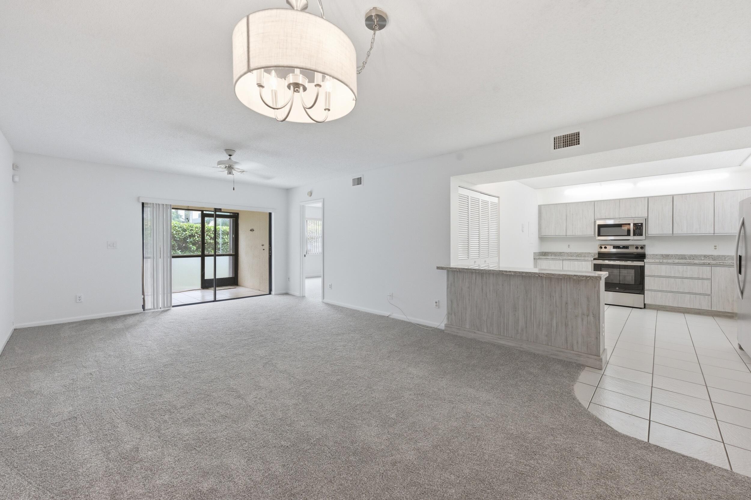 9633 Riverside Drive, Unit E3 Coral Springs, FL 33071 - Photo 5 of 31 a view of a kitchen with a sink dishwasher and a refrigerator