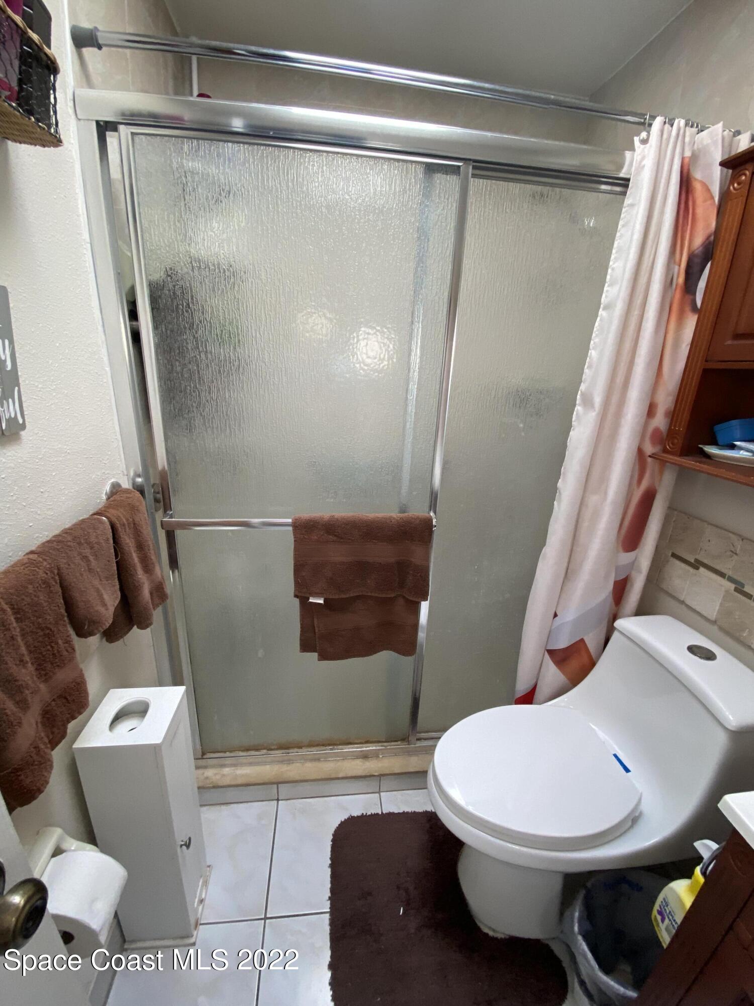 2807 Tropic Road Melbourne, FL 32935 - Photo 11 of 24 a bathroom with a toilet and a shower