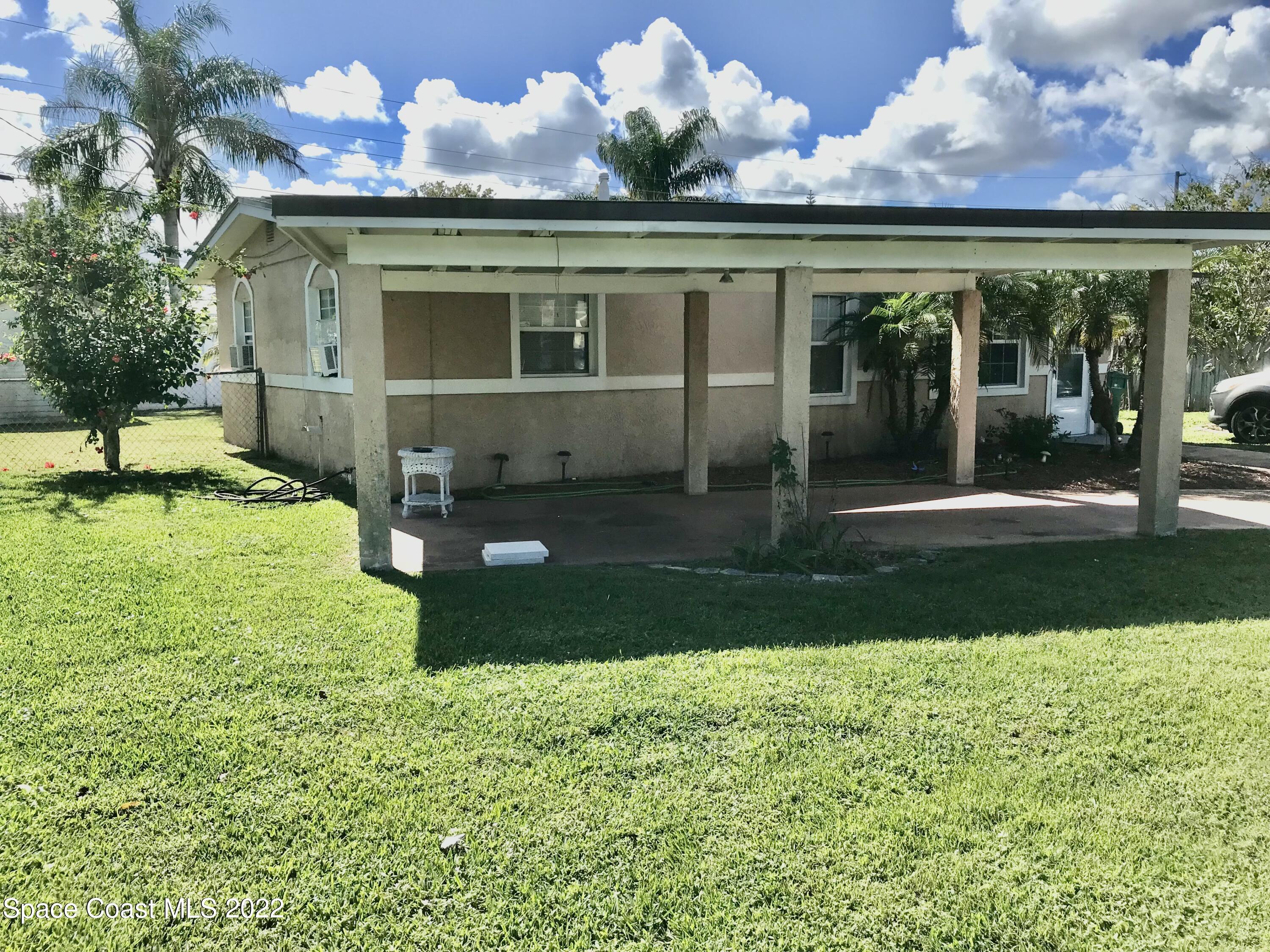 2807 Tropic Road Melbourne, FL 32935 - Photo 19 of 24 a front view of a house with a yard