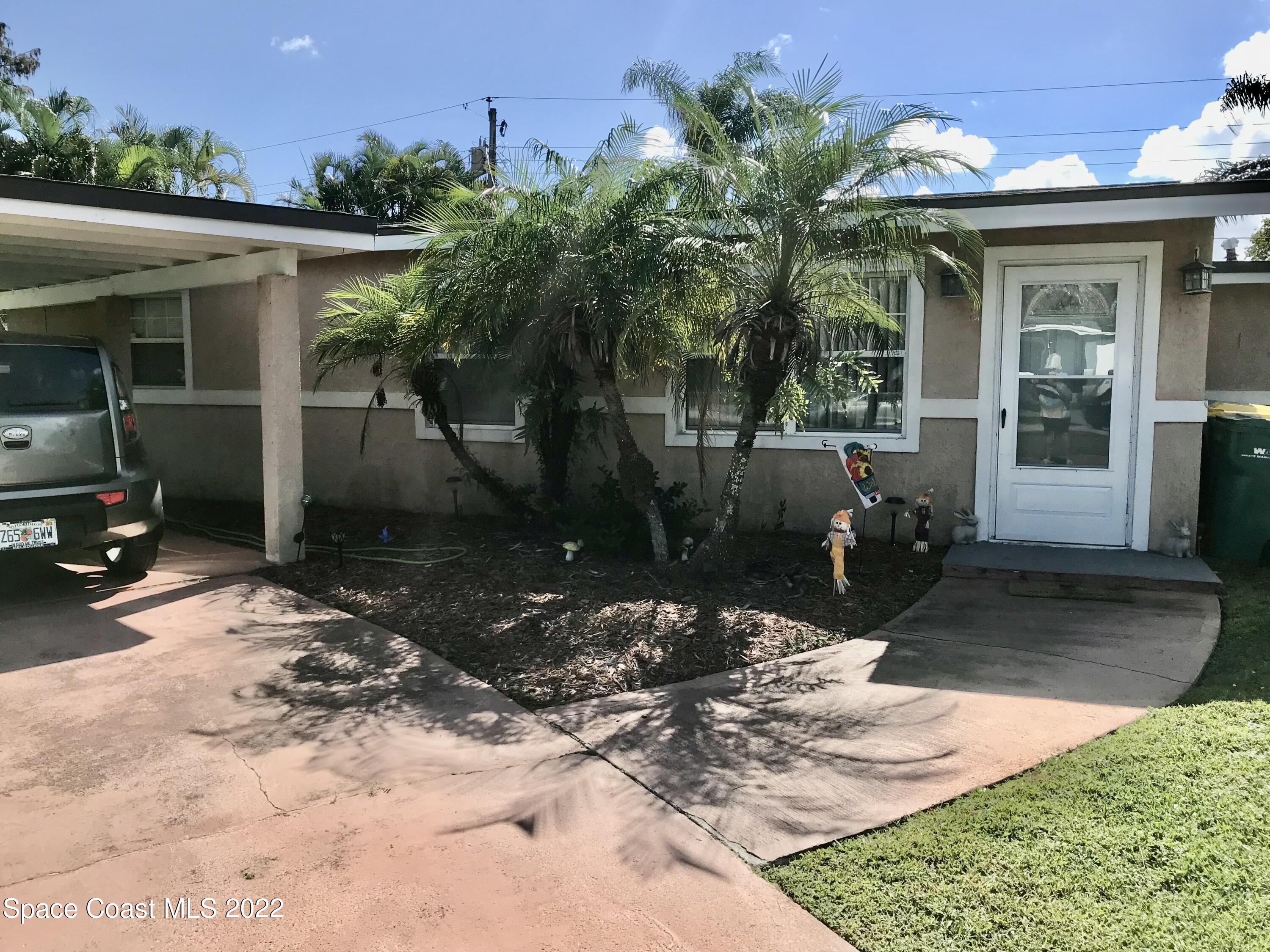 2807 Tropic Road Melbourne, FL 32935 - Photo 21 of 24 a view of a house with backyard and sitting area