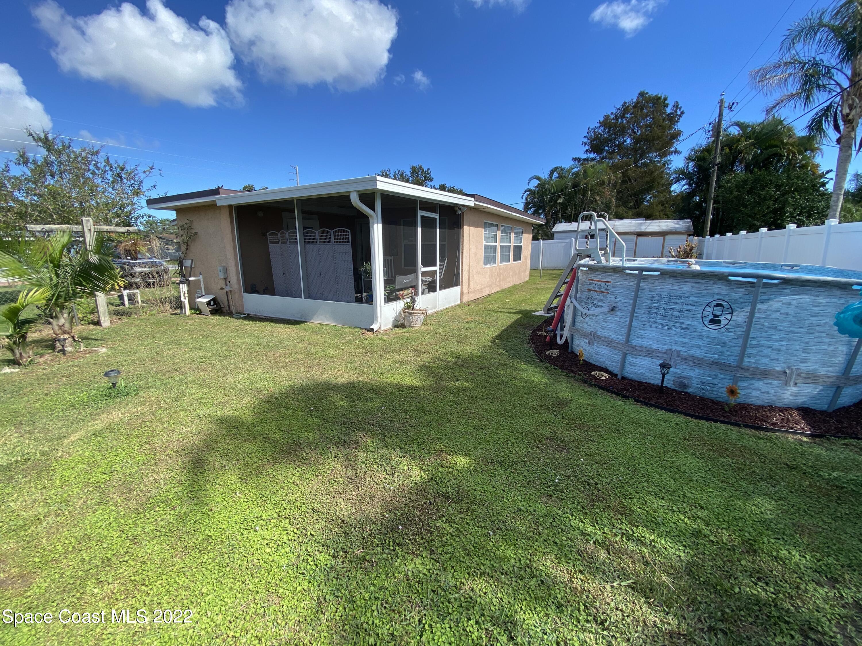 2807 Tropic Road Melbourne, FL 32935 - Photo 3 of 24 a backyard of a house with table and chairs