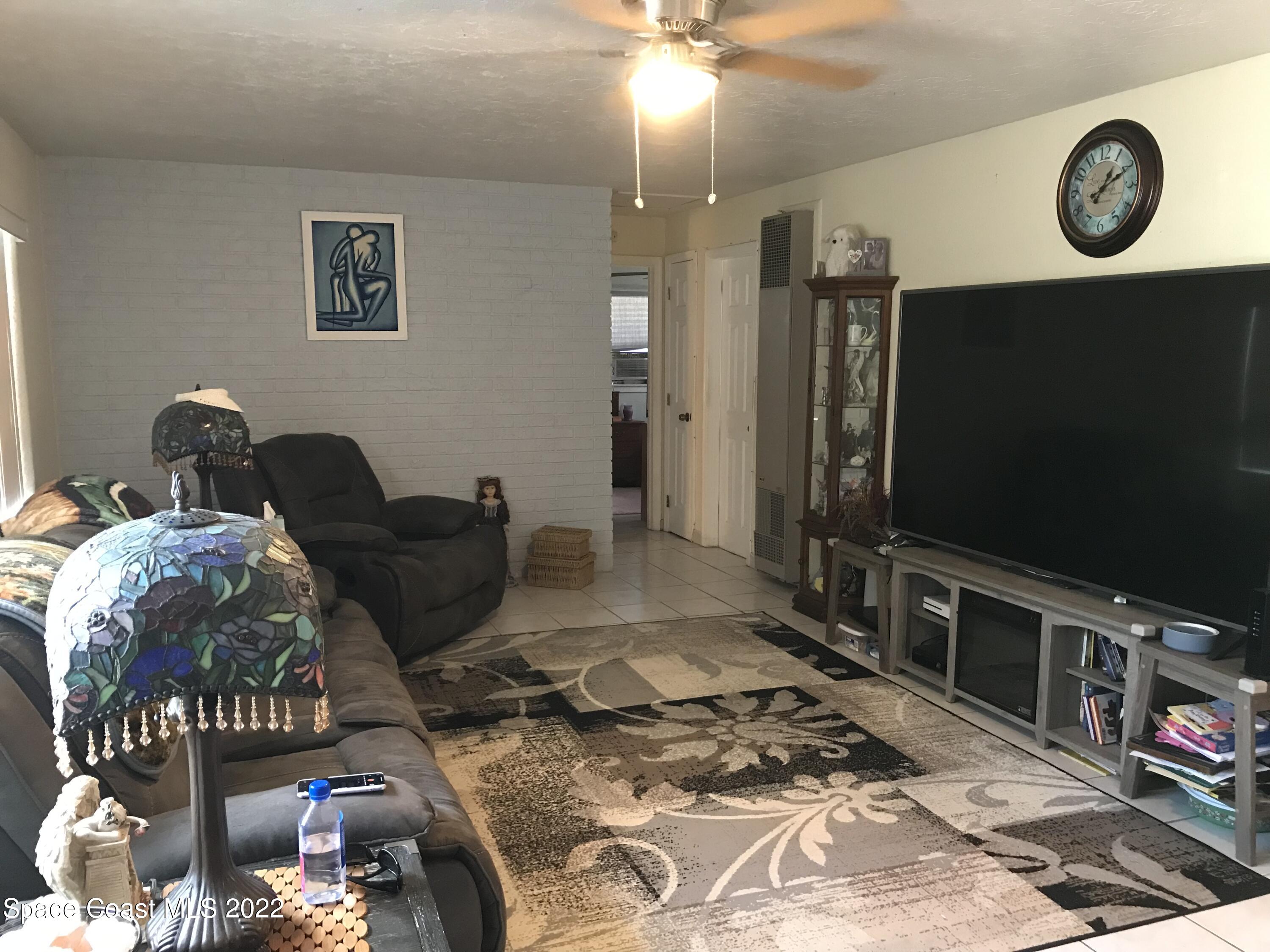 2807 Tropic Road Melbourne, FL 32935 - Photo 4 of 24 a living room with furniture and a flat screen tv