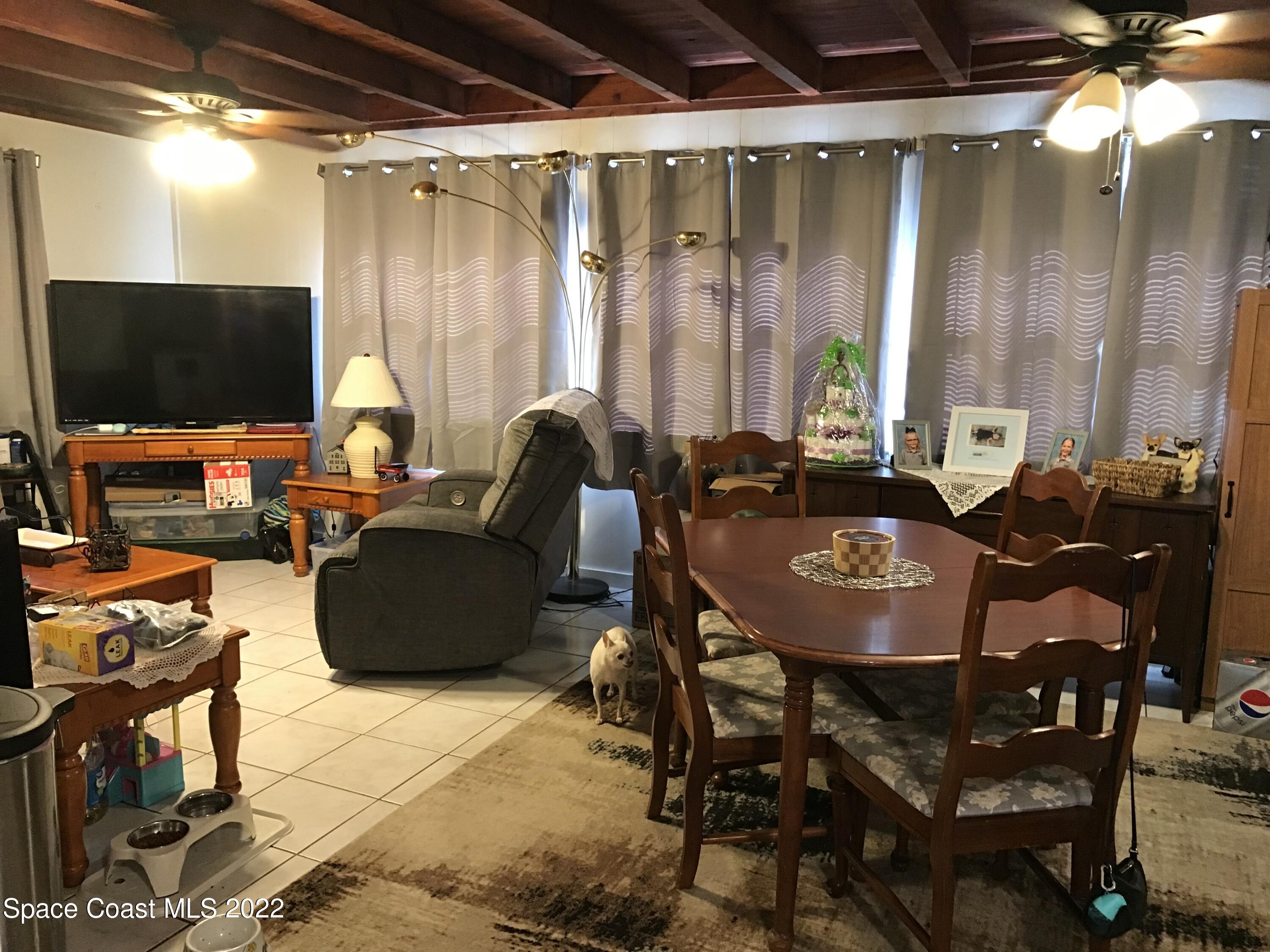 2807 Tropic Road Melbourne, FL 32935 - Photo 6 of 24 a living room with furniture and a flat screen tv
