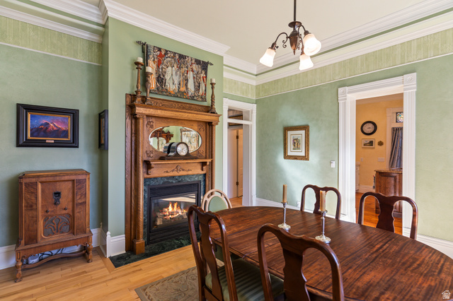 390 North 100 West Monroe, UT 84754 - Photo 16 of 167 Dining room featuring light wood-type flooring, a high end fireplace, a chandelier, and ornamental molding