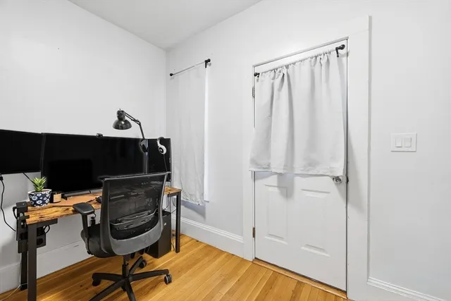 a view of a workspace with furniture and gym equipment