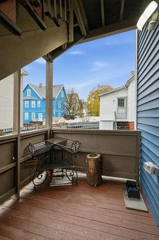 a view of a balcony with chair and wooden floor