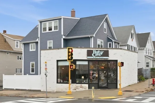 a view of a white house with large windows