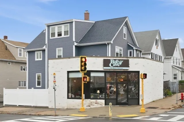 a view of a white house with large windows