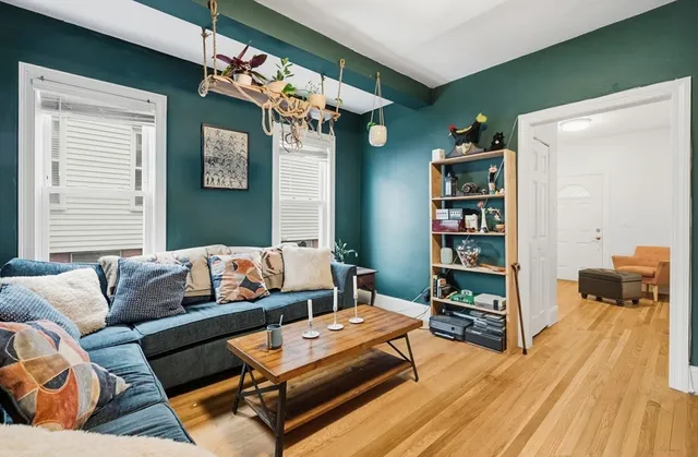 a living room with furniture and a book shelf