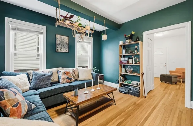 a living room with furniture and a book shelf