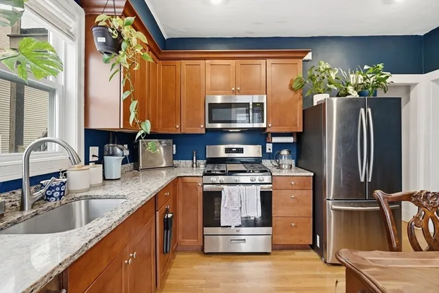 a kitchen with stainless steel appliances granite countertop a refrigerator sink and microwave