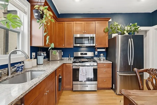 a kitchen with stainless steel appliances granite countertop a refrigerator sink and microwave