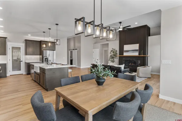 a kitchen with stainless steel appliances kitchen island granite countertop a kitchen island a stove a dining table and chairs