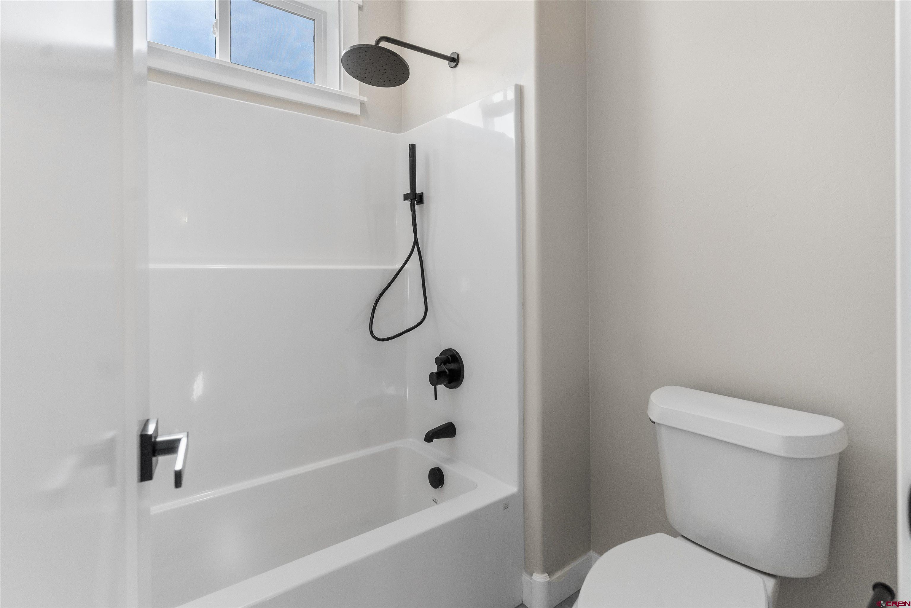 1539 Criterion Street Delta, CO 81416 - Photo 22 of 41 a white toilet sitting next to a bath tub