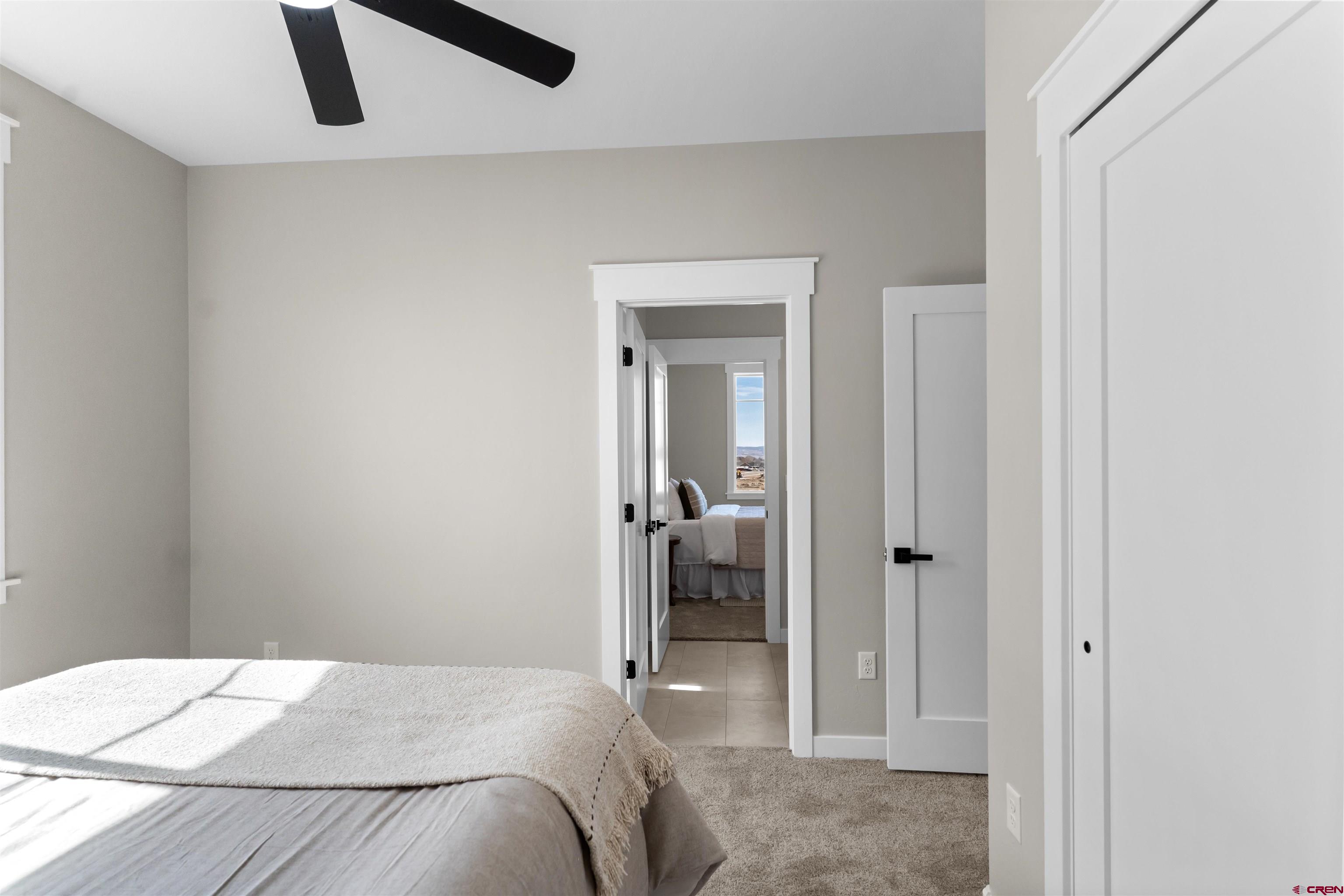 1539 Criterion Street Delta, CO 81416 - Photo 25 of 41 a bedroom with a bed and a chandelier