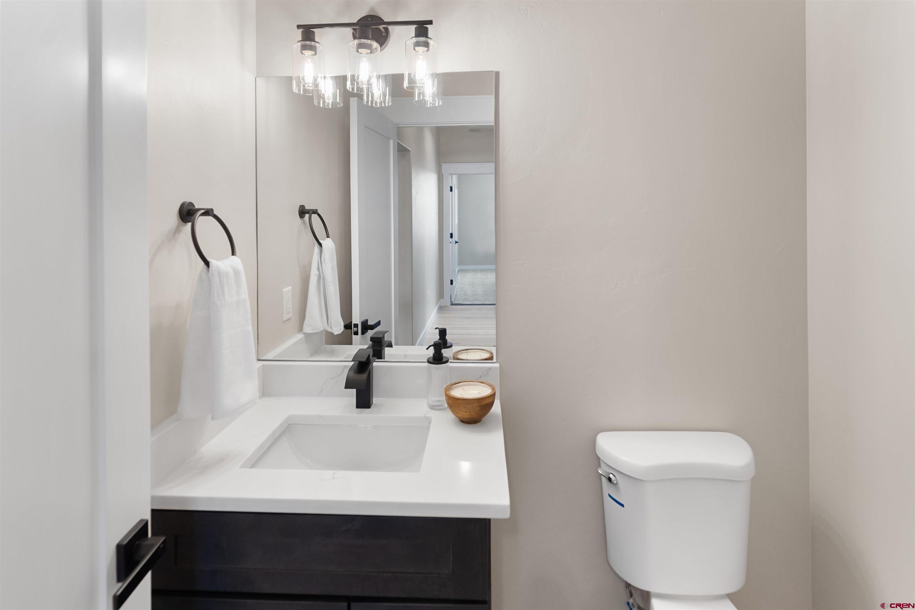1539 Criterion Street Delta, CO 81416 - Photo 26 of 41 a bathroom with a sink a toilet and mirror