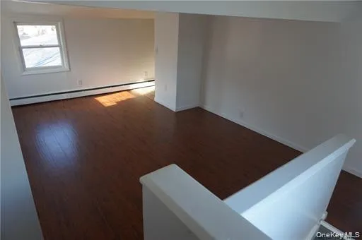 view of an empty room with wooden floor