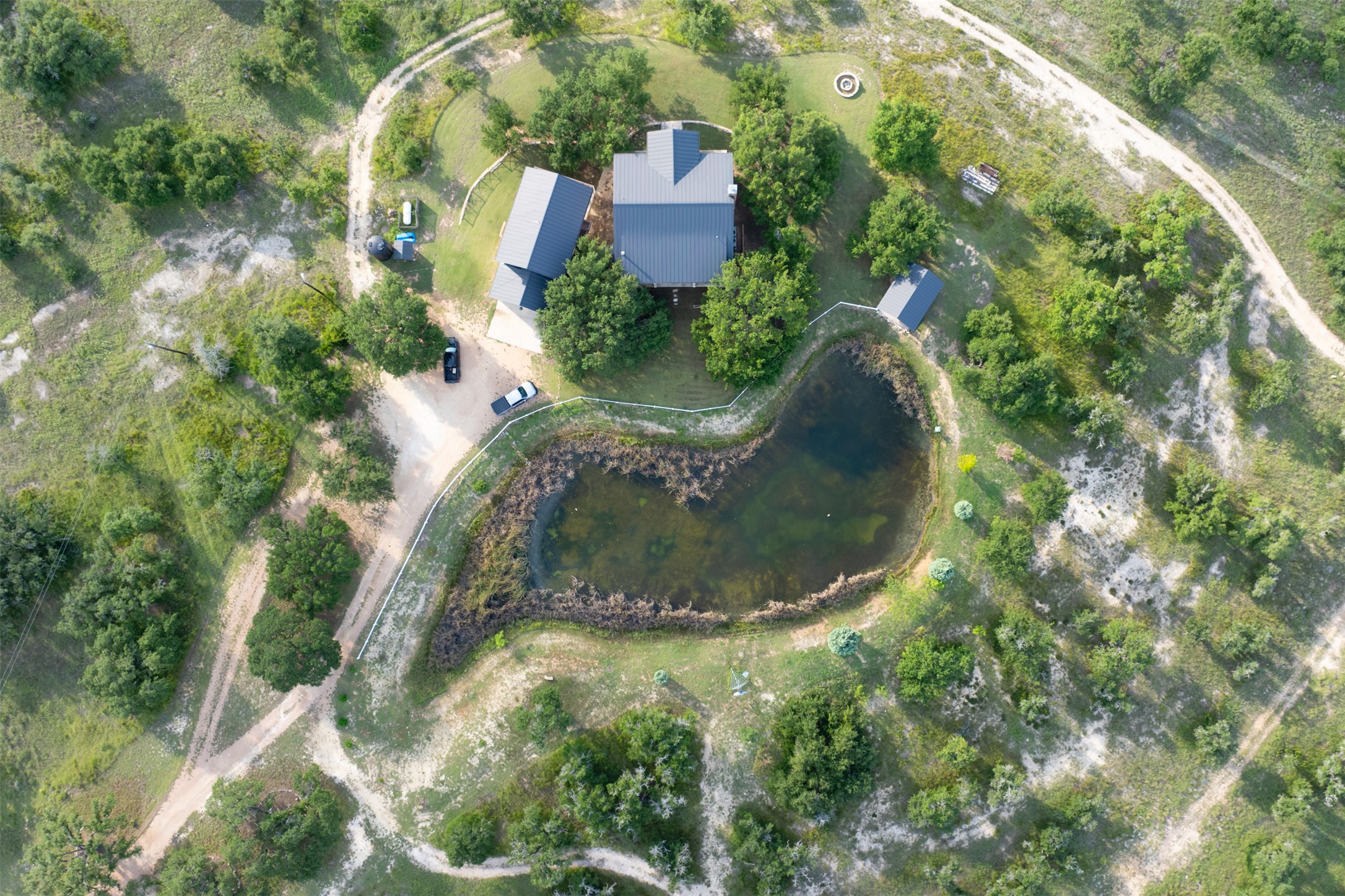 3149 Byrd Ranch Road Johnson City, TX 78636 - Photo 31 of 39 Aerial view of property and surrounding area with a large body of water