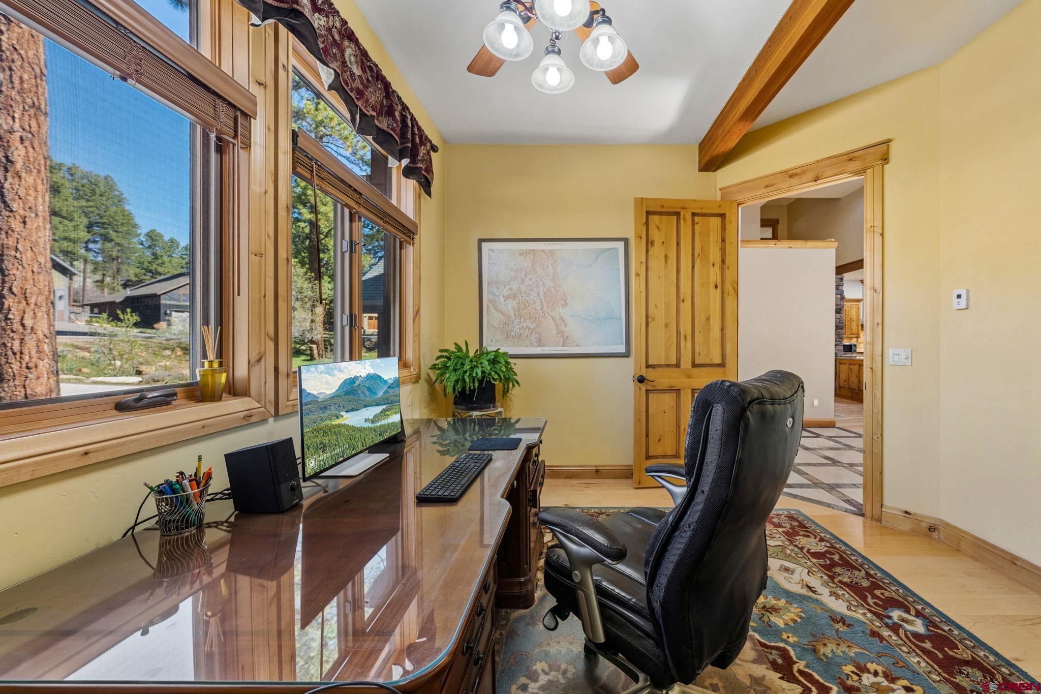 70 Clear Creek Loop Durango, CO 81301 - Photo 13 of 35 a view of a dining room with furniture window and wooden floor