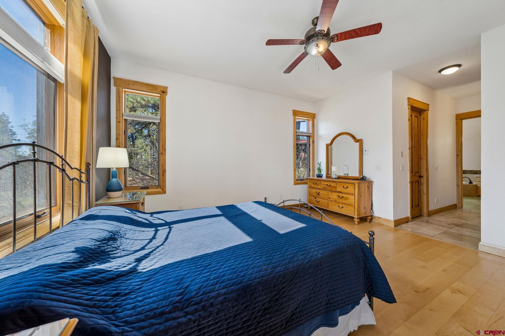 70 Clear Creek Loop Durango, CO 81301 - Photo 14 of 35 a bedroom with a bed and a chandelier