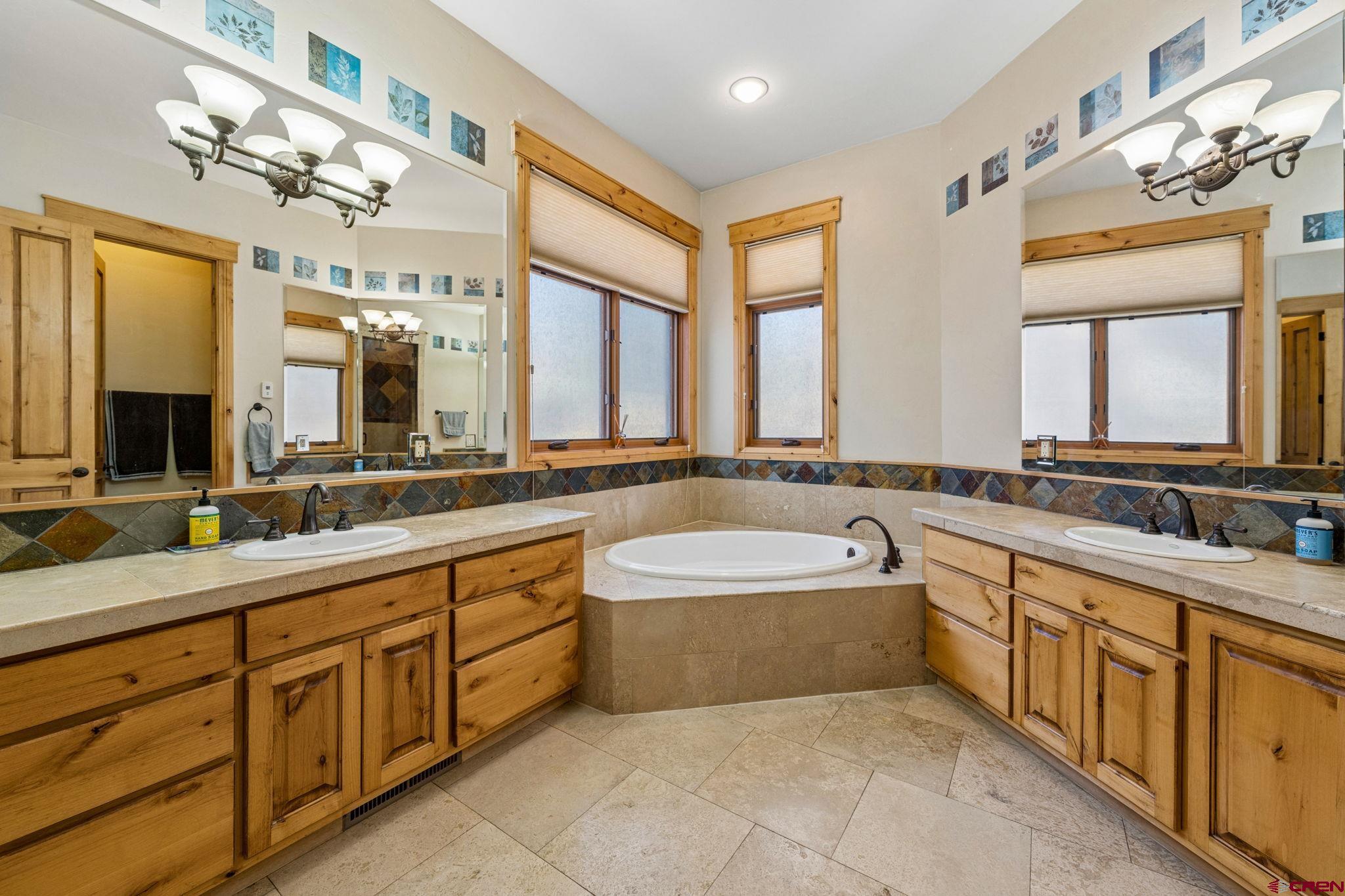 70 Clear Creek Loop Durango, CO 81301 - Photo 15 of 35 a spacious bathroom with a double vanity sink mirror and bathtub