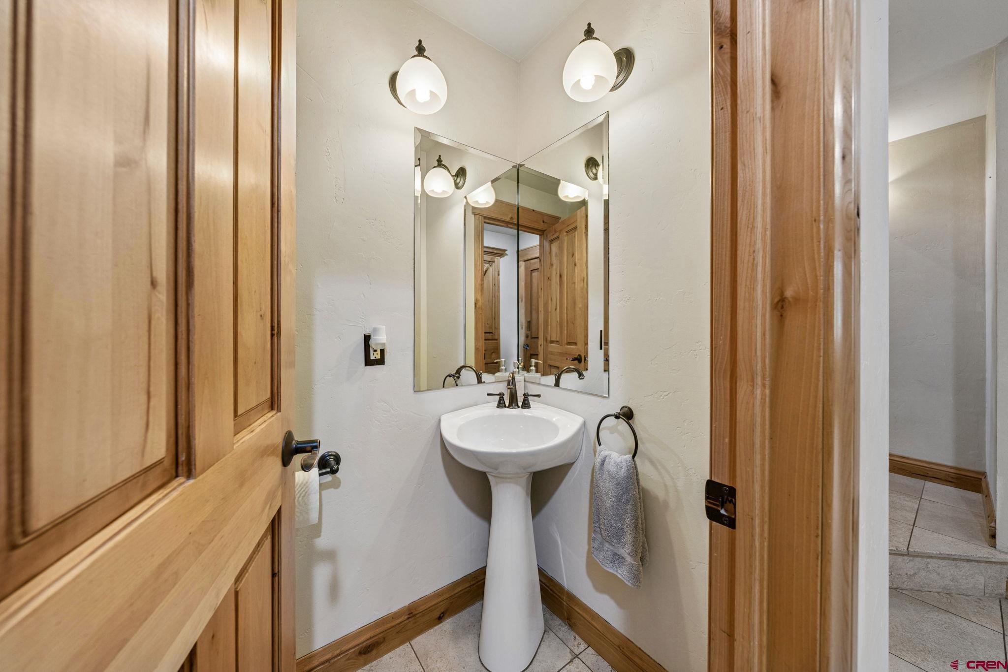 70 Clear Creek Loop Durango, CO 81301 - Photo 22 of 35 a bathroom with a sink a mirror and a shower