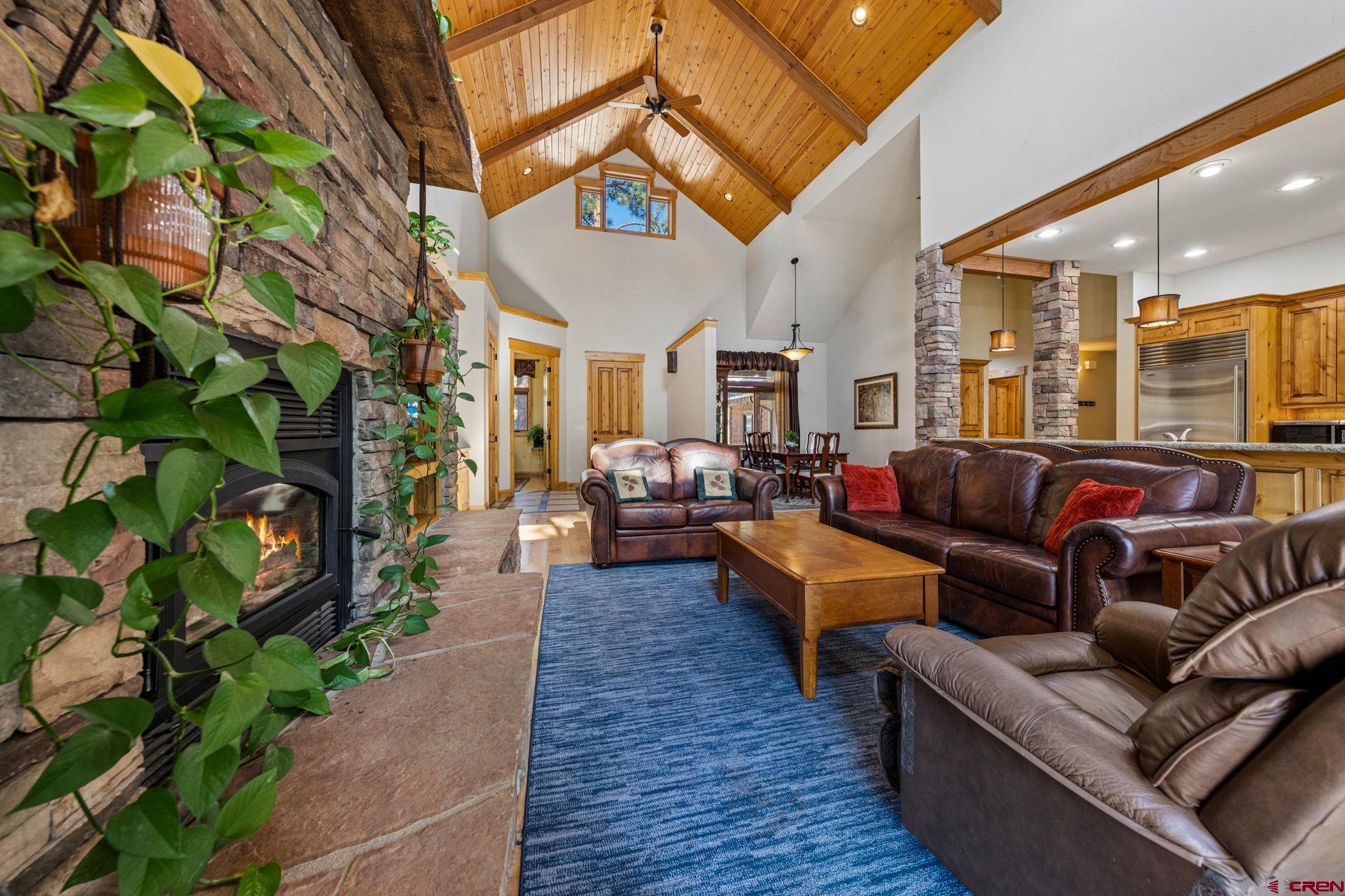 70 Clear Creek Loop Durango, CO 81301 - Photo 3 of 35 a living room with furniture a fireplace and a potted plant