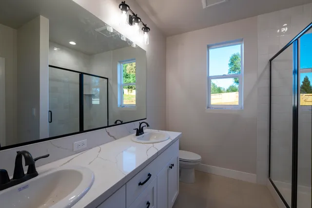 a bathroom with a double vanity sink and a mirror