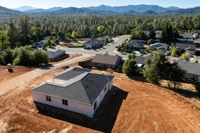 a view of a house with a mountain yard