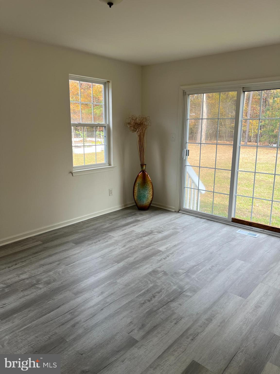 560 South Pitney Road Galloway Township, NJ 08205 - Photo 5 of 34 a view of an empty room with wooden floor and a window